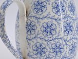 a blue and white pitcher sitting on a table