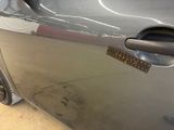 a close up of a car door handle with a sticker on it