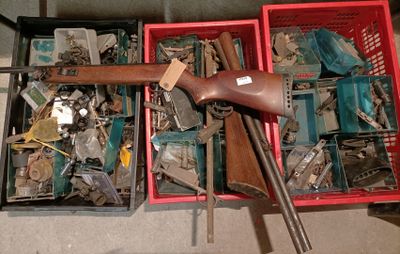 a red box filled with assorted items and a gun