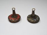 pair of antique brass candlesticks with red and yellow flowers