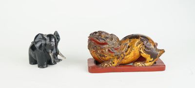 two figurines of elephants and an elephant sitting on a table