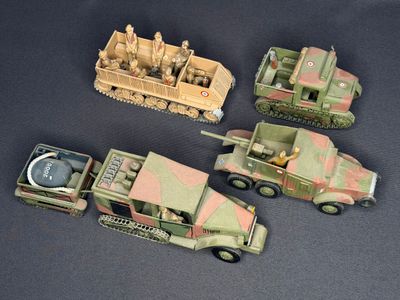 four toy army vehicles that are sitting on a table