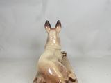 a figurine of a cat that is sitting on a table