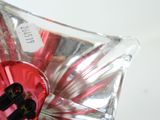 a glass vase with a red and black heart in it