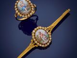 two gold - plated hair pins with a picture of a man and woman on them