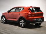 the rear end of a red volvo suv parked on a checkered floor