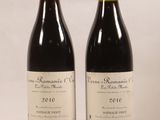 two bottles of wine sitting next to each other on a table