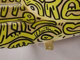 a yellow skateboard with black and white designs on it