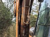 an image of a backhoe of a tractor in a field
