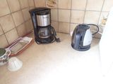 a coffee maker and a coffee pot on the kitchen counter