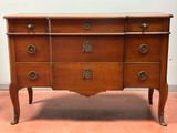 an antique chest of drawers with brass handles and drawers on each side