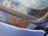 a close up of a car windshield with rust on it