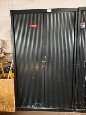 two metal doors that are open in a room