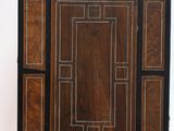 a wooden cabinet with a black and brown design on it