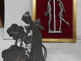 a statue of a lady and a man holding a flower