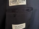 a close up of a black suit with a label on it