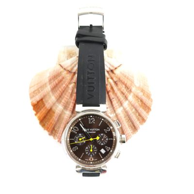 a watch that is sitting on top of a seashell