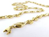 a close up of a gold necklace with a chain on a white surface