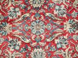 an image of a red and blue rug with a floral design