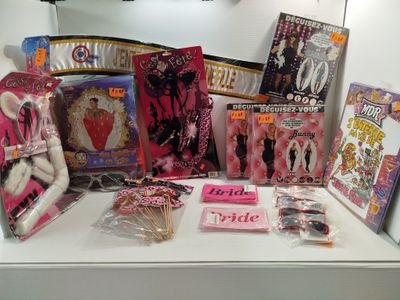 a lot of barbie dolls and other items on the counter