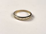 a close up of a gold ring on a white surface