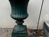 a green planter sitting on the side of a building