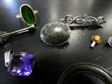 a black table with a bunch of jewelry on it