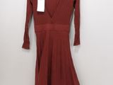 the dress is hanging on a hanger on the wall