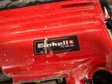 a red electric drill that is sitting on a table