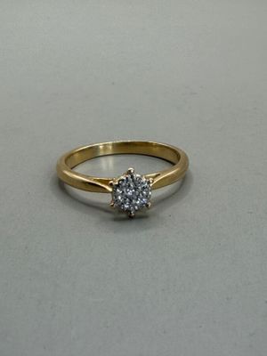 an image of a diamond ring on a table with a white background