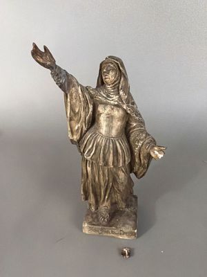 a statue of a woman that is standing on a table