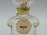 an image of a bottle of perfume with a stick sticking out of it