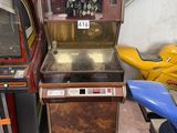 two old arcade machines sitting next to each other in a room