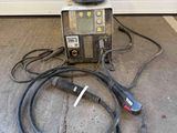 a welding machine and a hose on the ground