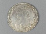 a close up of a silver coin with a woman on it