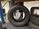two tires sitting on a shelf in a warehouse