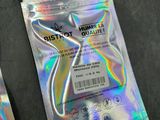 three packets of silver foil on a table