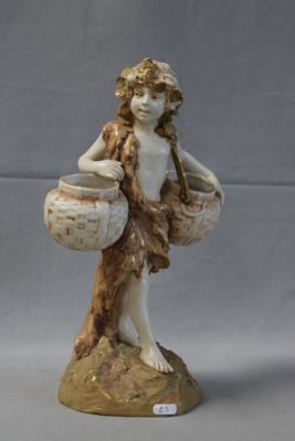 a figurine of a woman with a basket on a rock