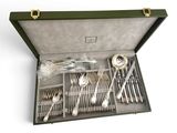 a green case with silverware in it on a white surface
