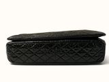 the black quilted purse is open and ready to be used