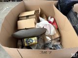 a cardboard box filled with assorted items in a warehouse