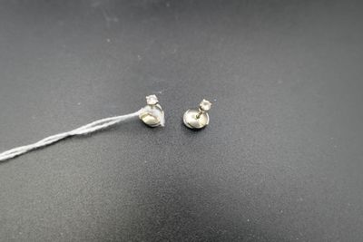 a close up of a pair of ear buds on a black surface