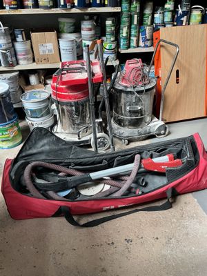 a red bag with tools in it sitting on the floor