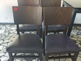 four chairs that are sitting in the middle of a room