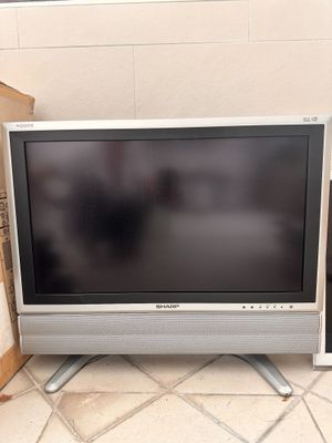 two televisions that are sitting next to each other on the floor