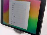 a tablet with a menu on the screen on the table
