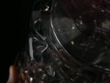 a person holding a crystal vase in their hand
