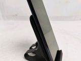 a cell phone that is on a stand on a table
