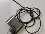 a close up of a charger on a table with a cord