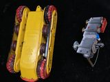 two toy vehicles that are sitting next to each other